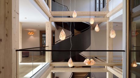 Pictures of a dream holiday in Bad Tölz Modern interior with wooden beams and black spiral staircase