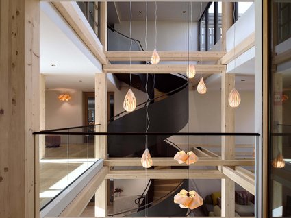 A holiday amidst nature in Germany Modern interior with wooden beams and black spiral staircase