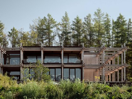 A holiday amidst nature in Germany Modern wooden house with large windows and garden in front of forest