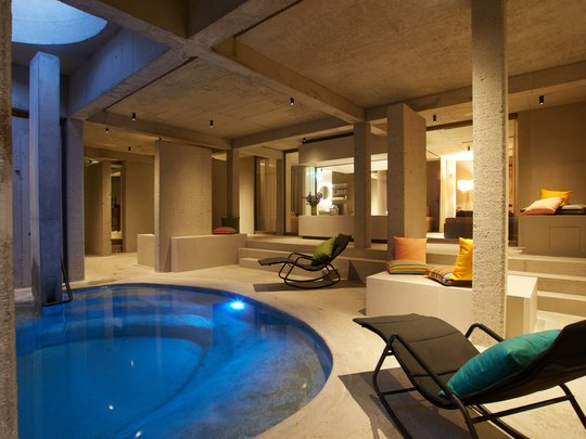 Holiday at BERGEBLICK in Bad Tölz Heated indoor pool with modern lounge chairs and cushions in a spa area
