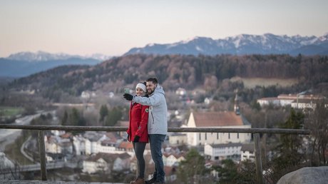 Pictures of a dream holiday in Bad Tölz Couple taking a selfie with mountains and town in the background