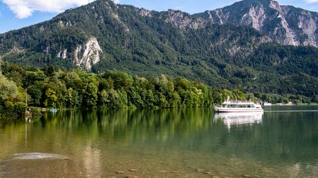 Pictures of a dream holiday in Bad Tölz Ferry on clear lake with forested mountains under blue sky