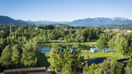 Pictures of a dream holiday in Bad Tölz View of lake and forest in park with mountains in background on sunny day