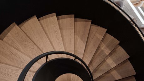 Pictures of a dream holiday in Bad Tölz Spiral wooden staircase with black railing in modern interior space