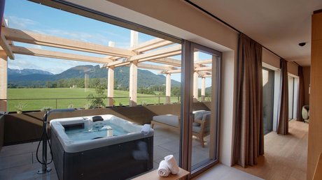 Pictures of a dream holiday in Bad Tölz Terrace with hot tub, lounge chair, and view of green mountains and fields