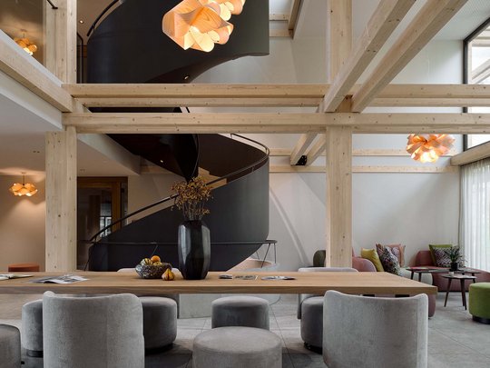 Holiday at BERGEBLICK in Bad Tölz Modern room with black spiral staircase and gray wooden seating furniture