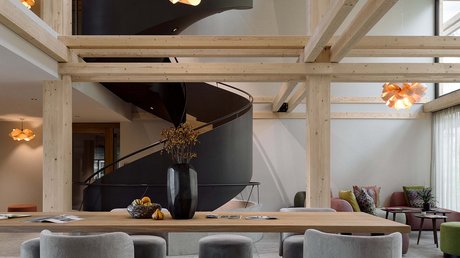 Pictures of a dream holiday in Bad Tölz Modern room with black spiral staircase and gray wooden seating furniture