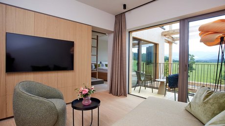 Pictures of a dream holiday in Bad Tölz Cozy living room with TV, armchair, table, balcony, and a view of nature