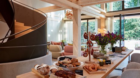 Pictures of a dream holiday in Bad Tölz Modern living kitchen with wooden staircase and table full of bread and pastries