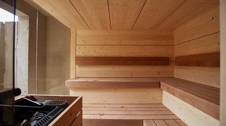 Pictures of a dream holiday in Bad Tölz Interior of a modern wooden sauna with benches and sauna heater