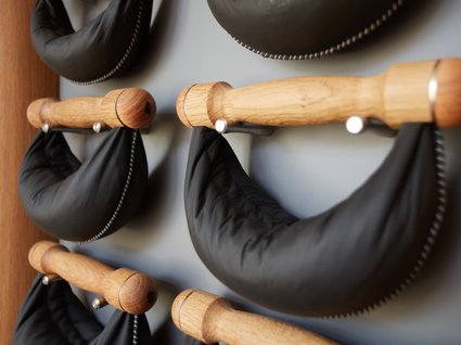 Your active holiday in Bavaria Black leather bags hanging on wooden handles on the wall