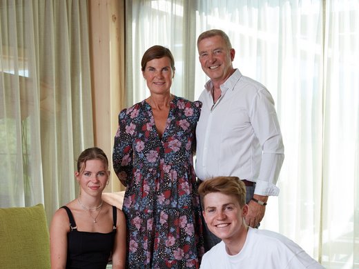 Wellness holiday in Bavaria Family with two adults, two teens, and a dog in the living room