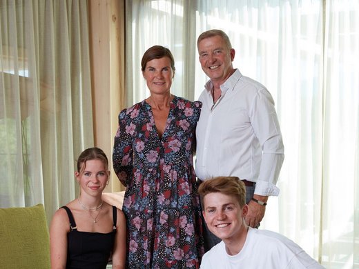 Wellness holiday in Bavaria Family with two adults, two teens, and a dog in the living room