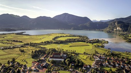 Pictures of a dream holiday in Bad Tölz Aerial view of meadow, village, lake, and mountains in the background