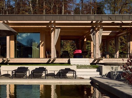 A holiday amidst nature in Germany Modern wooden pavilion with pool and sun loungers in autumn setting