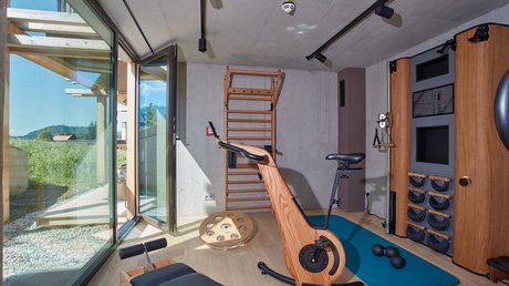 Pictures of a dream holiday in Bad Tölz Bright gym room with wooden equipment and open glass door showing outdoor greenery