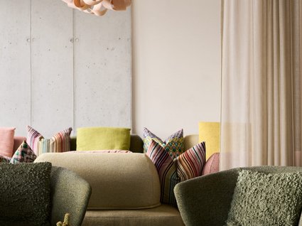 A holiday amidst nature in Germany Cozy living room with green chairs and colorful pillows