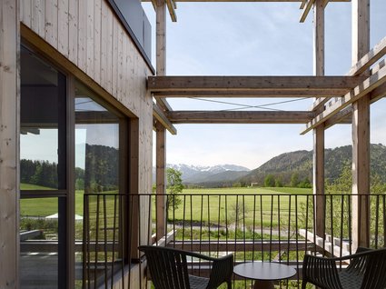 A holiday amidst nature in Germany Balcony with two chairs and table overlooking green fields and mountains