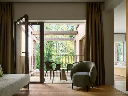 A holiday amidst nature in Germany Living room with balcony, green chairs, and view of green trees