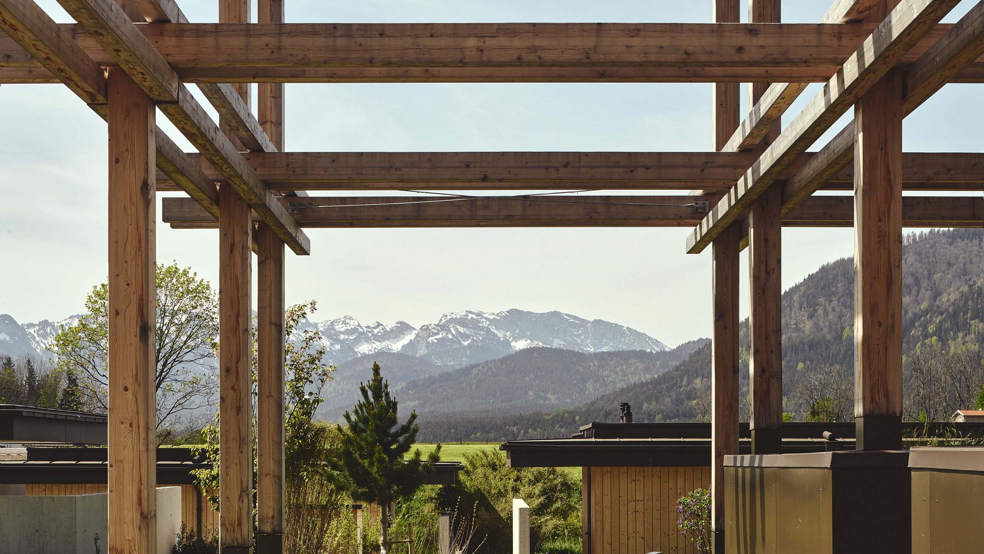 Hotel BERGEBLICK in Bavaria Wooden construction with view of mountains and green landscape in the background