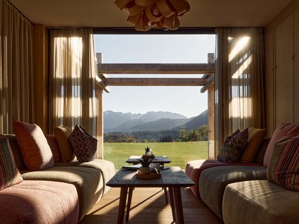A holiday amidst nature in Germany Cozy living room with view of green field and mountains in the background
