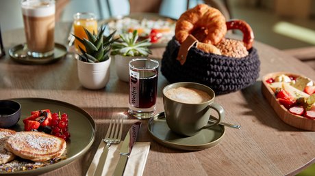 Pictures of a dream holiday in Bad Tölz Breakfast table with coffee, bread rolls, pancakes, and assorted drinks