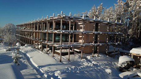 Pictures of a dream holiday in Bad Tölz Modern wooden building covered in snow with snowy trees and clear blue sky