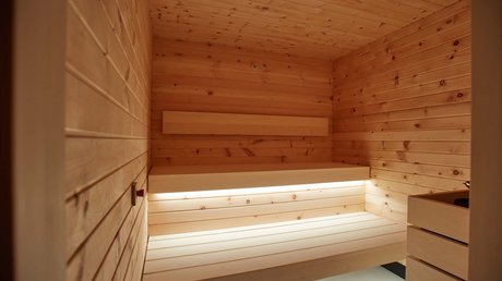 Pictures of a dream holiday in Bad Tölz Empty wooden sauna room with integrated lighting under upper bench